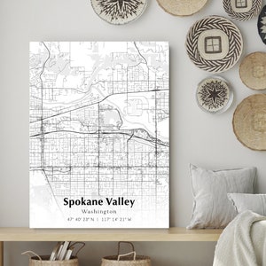 May include: A black and white map print of Spokane Valley, Washington. The map shows the city streets and landmarks. The text "Spokane Valley, Washington 47° 40' 23° N 117° 14' 21 W" is printed at the bottom of the map.