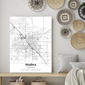May include: A black and white map print of Madera, California with the city's name and coordinates printed below the map.