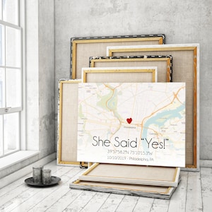 May include: A white canvas print with a map of Philadelphia, Pennsylvania. A red heart is placed on the map with the text "She Said "Yes!" 39'57'58.2"N 75&deg;10'15.3"W 10/10/2019 - Philadelphia, PA".