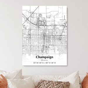 May include: Black and white map of Champaign, Illinois. The map shows the city streets and landmarks. The text "Champaign, Illinois" and the coordinates "40° 06' 59" N | 88° 14' 36" W" are printed below the map.