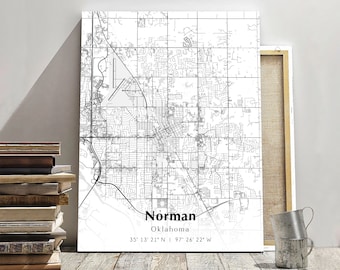 May include: A black and white line art map of Norman, Oklahoma. The map shows the city streets and landmarks. The text "Norman, Oklahoma" and the coordinates "35° 13' 21" N | 97° 26' 22" W" are printed below the map.
