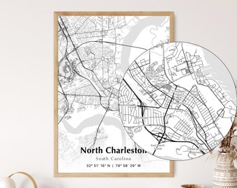 May include: A framed black and white map print of North Charleston, South Carolina, with a detailed inset. The map includes street names and coordinates 32° 51' 16" N 79° 58' 29" W. The print is in a light wood frame.