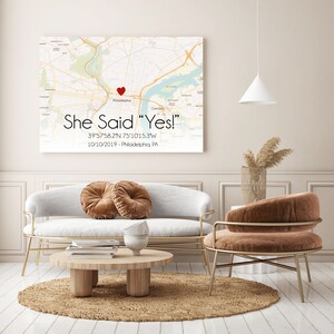 May include: A white canvas print with a map of Philadelphia, Pennsylvania. A red heart marks the location of the city. The text "She Said "Yes!" 39&deg;57'58.2"N 75&deg;10'15.3"W 10/10/2019 - Philadelphia, PA" is printed below the map.