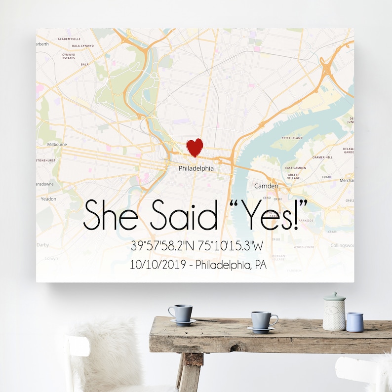 May include: A map of Philadelphia, Pennsylvania with a red heart marking the location of the city. The text "She Said "Yes!" 39&deg;57'58.2"N 75&deg;10'15.3"W 10/10/2019 - Philadelphia, PA" is printed below the map.