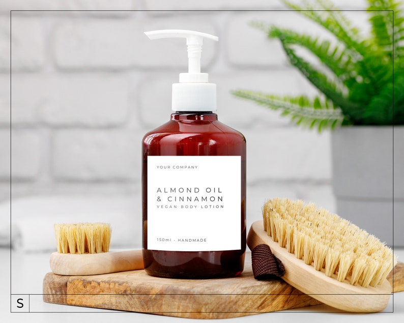 May include: A brown bottle with a white pump dispenser filled with almond oil and cinnamon vegan body lotion. The bottle has a white label with the text "Your Company, Almond Oil & Cinnamon, Vegan Body Lotion, 150ml - Handmade".