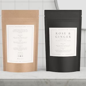 May include: Two all-natural body scrub pouches. One is tan with a white label, the other is black with a white label. The tan pouch has text that reads "Your Brand Name" and "A gentle removal exfoliating scrub". The black pouch reads "Rose & Ginger".