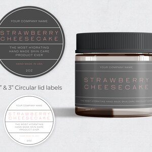 May include: Two circular labels with black borders and white backgrounds. The labels feature the text "YOUR COMPANY NAME", "STRAWBERRY CHEESECAKE", "THE MOST HYDRATING HAND MADE SKIN CARE PRODUCT EVER", "HAND MADE IN USA", and "2OZ". The labels are for a 2-inch and 3-inch jar lid. A glass jar with a black lid and a label that reads "YOUR COMPANY NAME", "STRAWBERRY CHEESECAKE", and "THE MOST HYDRATING HAND MADE SKIN CARE PRODUCT EVER".