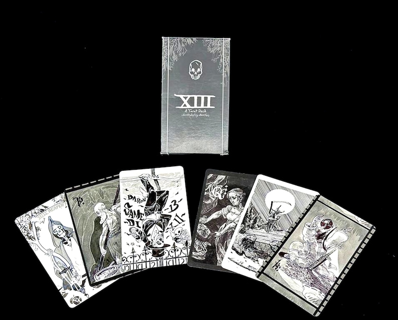May include: A set of playing cards with black and white illustrations. The cards feature a skull and the text "XIII A Tarot Deck illustrated by Martin."
