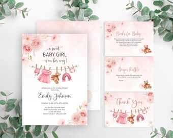 May include: A pink and white baby shower invitation with a watercolor floral design. The invitation features a clothesline with a pink dress, a teddy bear, and a rainbow hanging from it. The text reads "a sweet baby girl is on her way!" and includes the name "Emily Johnson" and the date and time of the shower.