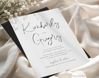 May include: A white wedding invitation card with black text featuring the names Kimberly and Gregory, date Saturday, 26th August 2027, location Davenport House, Bridgenorth WV15 5LE, and RSVP details, resting on a black envelope and cream fabric.