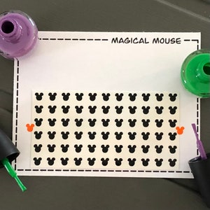 May include: A sheet of black Mickey Mouse head stickers on a white background. The sheet is labeled "Magical Mouse".