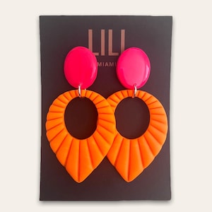 Neon orange and neon pink Art Deco drop earrings made from polymer clay
