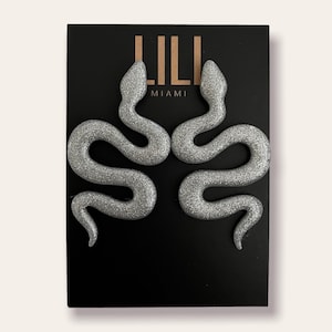 Silver glitter snake earrings made from polymer clay