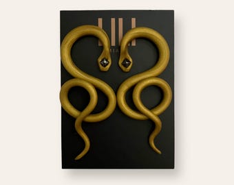 Handmade gold snake earrings made from polymer clay