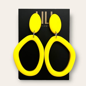 軽量でポリマー粘土から作られた、有機的な形のソリッドイエローフープ。