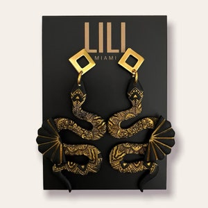 Black and gold snake dangle earrings made from polymer clay
