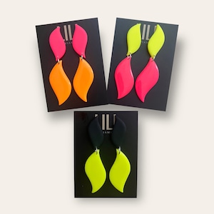 Neon pink and neon orange leaf shaped drop earrings handmade from polymer clay