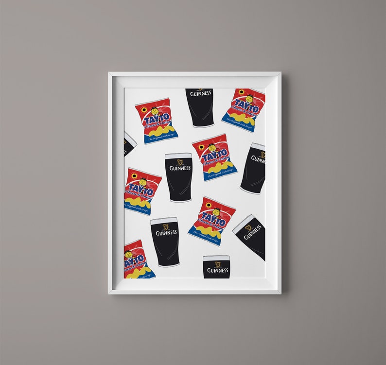 May include: A white framed print with a repeating pattern of black Guinness pints and red and yellow Tayto crisps bags. The print features the text "Guinness" and "Tayto" on the packaging.