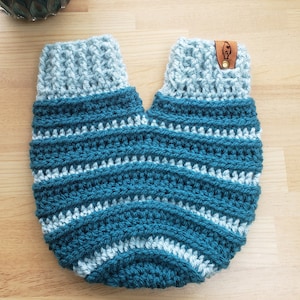 A crochet mitten with two openings for a couple tohold hands