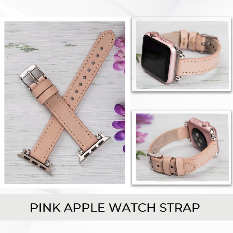 May include: A pink leather Apple Watch strap with silver hardware. The strap is shown on a light wood surface.