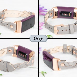 May include: A braided gray leather band with a rose gold buckle and a purple fitness tracker. The band is designed for the Fitbit Inspire 2.