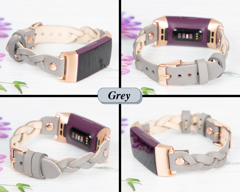May include: A braided gray leather band with a rose gold buckle and a purple fitness tracker. The band is designed for the Fitbit Inspire 2.