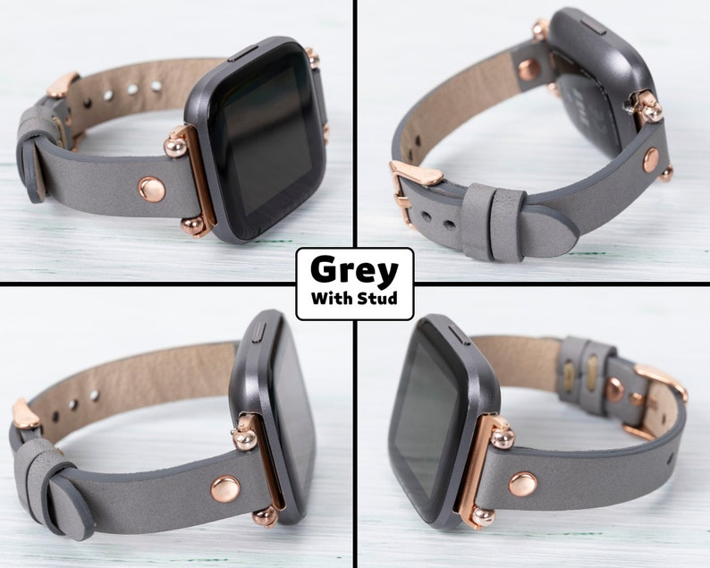 May include: A gray leather watch band with rose gold accents and studs. The band is compatible with a square-shaped smartwatch.