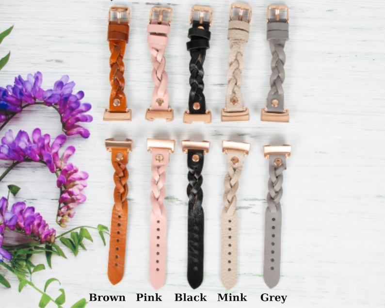May include: Five braided leather watch bands in different colors: brown, pink, black, mink, and gray. Each band has a rose gold buckle.