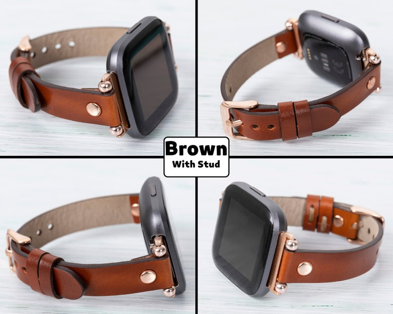 May include: Brown leather watch band with rose gold studs and buckle. The band is compatible with Fitbit Versa smartwatches.