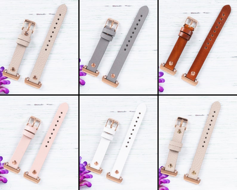 May include: Six pairs of watch bands in different colors and materials. The bands are shown on a white wooden background. The bands are all the same size and have a rose gold buckle.