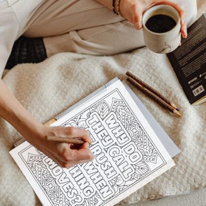 May include: A black and white colouring page with a mandala design and the text "Why do they call it rush hour when nothing moves?"