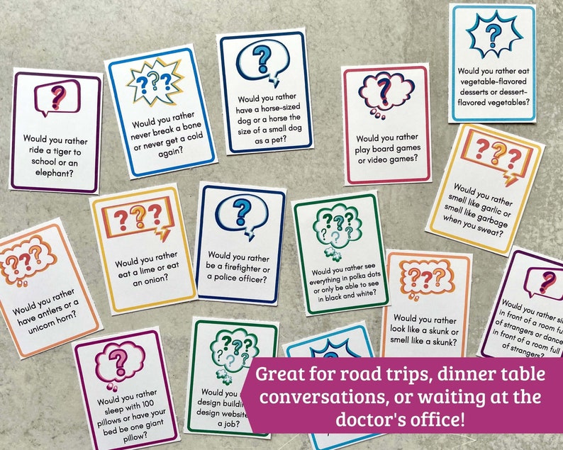 May include: A set of colorful cards with thought-provoking questions for conversation starters. The cards feature a question mark symbol and text that reads "Would you rather..." followed by a choice between two options. The cards are ideal for road trips, dinner table conversations, or waiting at the doctor's office.