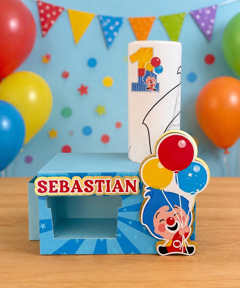 May include: A blue box with the name "SEBASTIAN" in red and gold lettering, a white candle with a "1" and cartoon character, and a cartoon character holding balloons. Colorful balloons and a banner are in the background.