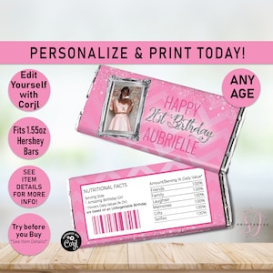 May include: Pink and silver printable chocolate bar wrapper featuring a photo frame and the text "Happy 21st Birthday Aubrielle". The wrapper is designed to fit a 1.55 oz Hershey bar.