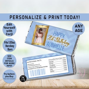 May include: A blue and gold personalized chocolate bar wrapper with a photo of a person in a pink dress. The wrapper says "Happy 21st Birthday Aubrielle".