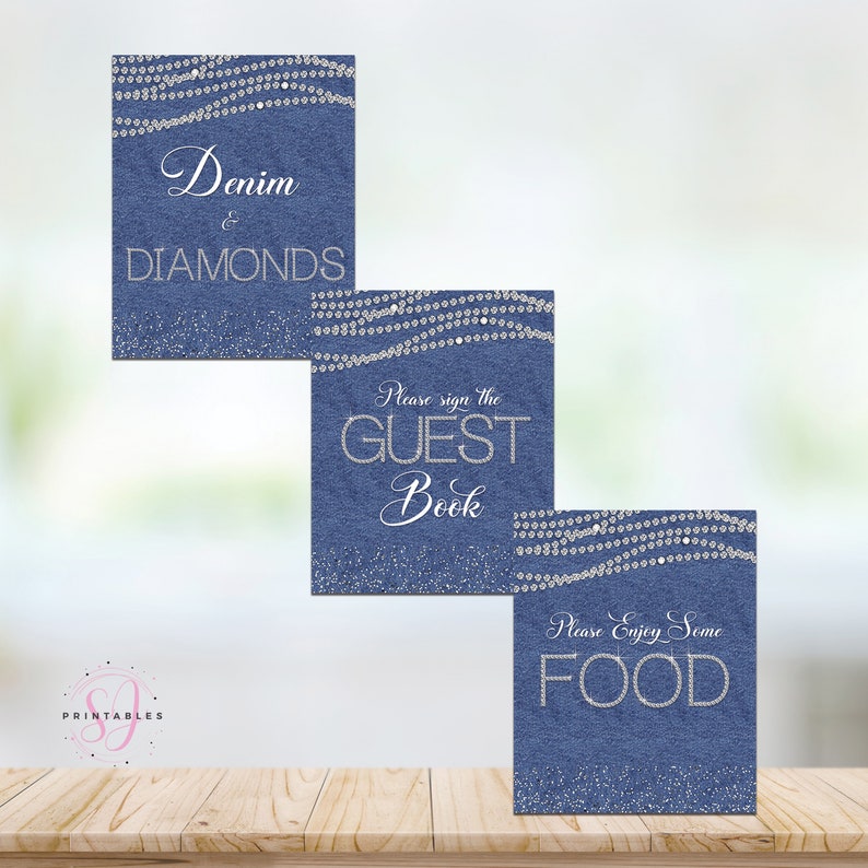 May include: Three blue denim signs with silver glitter and rhinestones. The top sign says "Denim & Diamonds". The middle sign says "Please sign the Guest Book". The bottom sign says "Please Enjoy Some Food".