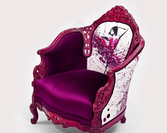 May include: A pink velvet armchair with a white and pink floral print on the back. The chair has a carved wooden frame and ornate legs.