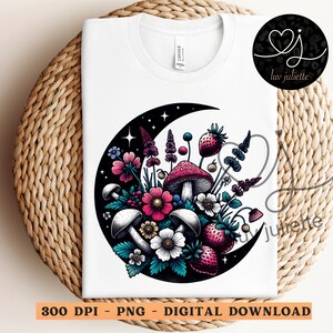 May include: A white t-shirt with a black crescent moon design featuring a cluster of colorful flowers, mushrooms, and berries. The design is in a vintage style with intricate details.
