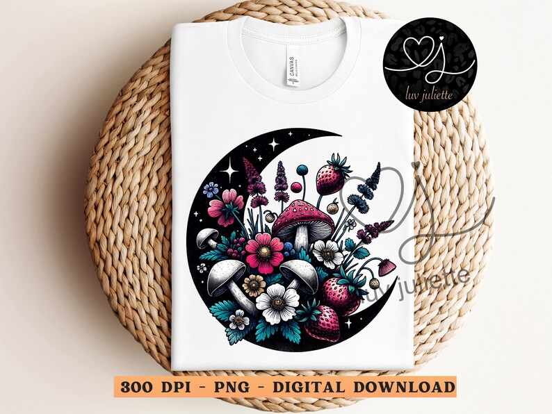 May include: A white t-shirt with a black crescent moon design featuring a cluster of colorful flowers, mushrooms, and berries. The design is in a vintage style with intricate details.