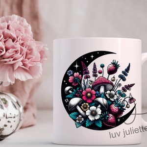 May include: White ceramic mug with a crescent moon design featuring a colorful bouquet of flowers, mushrooms, and strawberries. The text "luv juliette" is printed on the bottom of the mug.