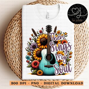 Pu&ograve; includere: Un download digitale di un design grafico con una chitarra acustica blu con accenti floreali e il testo "Then Sings My Soul".