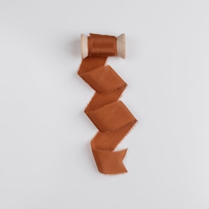 Oriole Frayed Edge Silk Ribbon with Wooden Spool Flat Lay Styling Ribbon burnt orange
