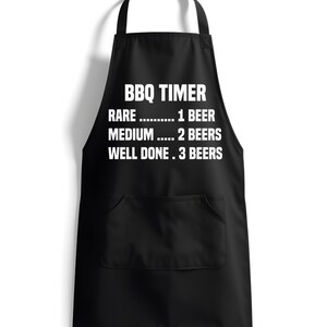May include: Black BBQ apron with white text that reads "BBQ TIMER" and a list of doneness levels for meat with corresponding beer counts: "RARE...1 BEER", "MEDIUM...2 BEERS", "WELL DONE...3 BEERS".
