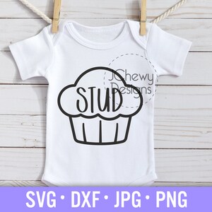 May include: A white baby onesie with a black outline of a cupcake with the word "STUD" inside. The onesie is hanging on a clothesline with wooden clothes pegs.