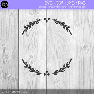 May include: A black and white wreath design with two sets of leaves and berries. The design is on a white wood background.