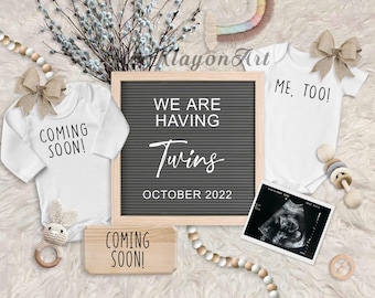 May include: A pregnancy announcement with two white onesies, one saying "Coming Soon!" and the other saying "Me, Too!"  A letter board says "We are having Twins October 2022".  There are wooden beads, a wooden rattle, a crocheted bunny rattle, and an ultrasound image.