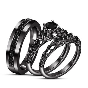 May include: A black wedding band set with a delicate, intricate design. The engagement ring features a black gemstone surrounded by smaller black gemstones. The wedding band is a simple band with black gemstones embedded in the metal.