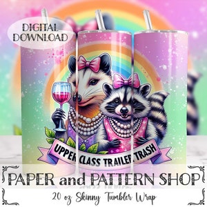 May include: A 20 ounce skinny tumbler wrap featuring a colorful rainbow background with a raccoon and a possum wearing pearl necklaces and holding wine glasses. The text "Upper Class Trailer Trash" is written on a banner.