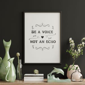 May include: A framed print with the text "BE A VOICE NOT AN ECHO" is displayed on a wooden shelf. The shelf also holds green cat-shaped vases, a dolphin sculpture, books, and decorative vases with flowers.