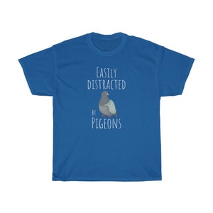 May include: A royal blue t-shirt with the text "EASILY DISTRACTED BY PIGEONS" and a cartoon image of a pigeon.